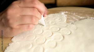 Cutting letter shapes out of rolled out sugar marzipan fondant