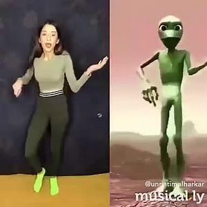 Green Alien dancing with a girl