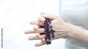 woman praying and holding cross in her hands on white background stock video