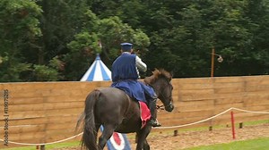 Slow motion view of display of medieval archery skills at a joust