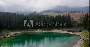 Lake Karezza, mountain lake famous. Reflection of the Rose Garden Mountain in the Lake. In 2018, a massive storm destroyed all the trees in the area. South Tirol, Italy