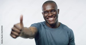 Man, thumbs up and face in studio for fitness, health and excited for agreement by white background. Happy African person, emoji and yes icon with sign language, review and feedback for exercise