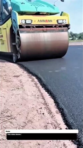 Modern Asphalt Compactor – AMMANN Road Roller Perfectly Flattening Fresh Pavement.