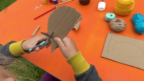 clip-3977388467-construct-fish-figure-cardboard-thread-paint-detailed