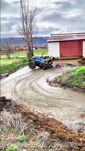 Hauling the Mire: A Loader Clears Mud from a Rural Road