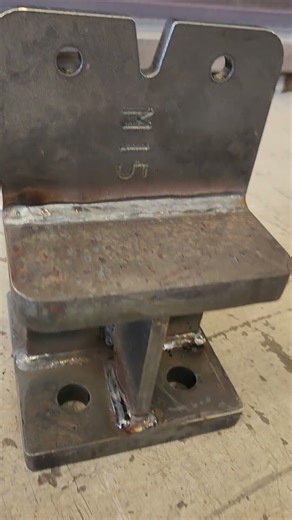 Binderholz GLT Column connection steel stub anchoring to concrete footing.