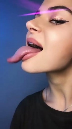 the longest tongue. the girl shows a tongue. the girl sticks out her tongue. the girl's long tongue