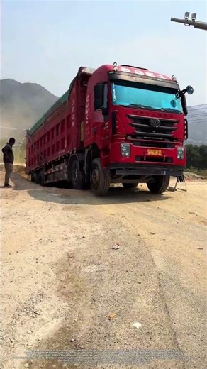 Super-heavy dump truck climbing an earthen slope