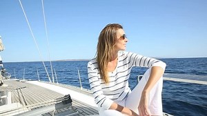 Attractive modern woman enjoying sailing cruise