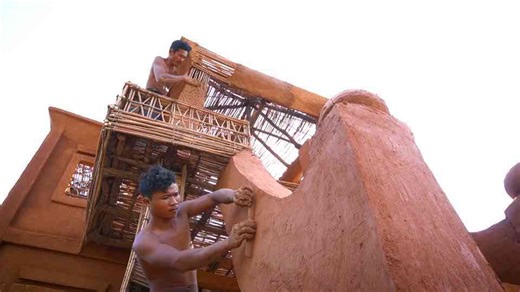 The mud walls went up fast, until the tile roof took over the whole build