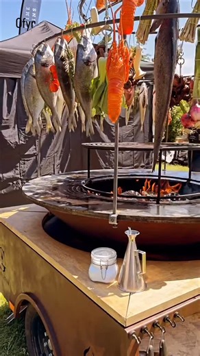 OFYR USA 🌎 Live Fire Cooking on Instagram: "🔥 Witness the Art of Outdoor Cooking Like Never Before @tournebrochegueuleton puts on an incredible open-fire performance using the iconic OFYR and the jaw-dropping Cage Terre et Mer accessory — turning fresh fish, lobster, meats, and seasonal vegetables into a true culinary spectacle for the crowd. ✨ This dynamic setup shows the unmatched versatility and capacity of the OFYR grill — searing, roasting, and smoking a feast over a roaring flame, all at