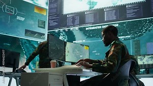 Military personnel in a control center working on data processing, integrating real time surveillance and security protocols essential for national defense and strategic operations. Camera B.