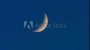 Celestial Elegance: Moving Shot of Crescent Moon Captured with a Long Telephoto Lens, Immersed in Stunning 4K Resolution