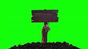 Zombie Hand with Wooden Sign Crawling Out of the Ground on Green Screen