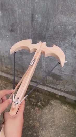 Shooting an arrow from a bat-shaped crossbow slingshot 1