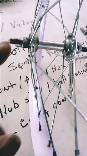 using two hands to remove nut on front axle