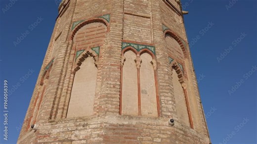 View of the second uppermost level of Torre del Oro in Seville, Spain, against a blue sky