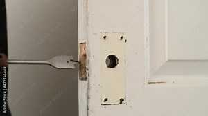 An electric drill making a hole for a door lock