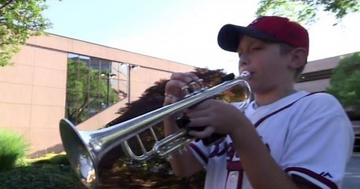 Boy plays trumpet as a tribute to front-line workers