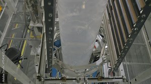 Industrial equipment deals with plastic material compounding at the plant. Blowing the plastic material into the big tube for industrial compounding. Industrial raw plastic compounding process.