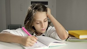 Tired schoolboy falls asleep doing his homework. Back to school.