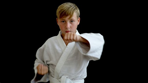 Child practicing his technique in a karate Gi - Free Stock Video