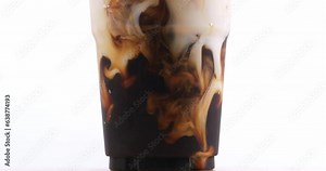 4K footage Front view SLO MO, Pouring freshly brewed americano coffee into a glass of water with ice on a white background.