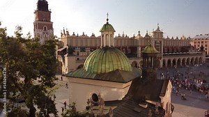 Cracow's Main Market (Krakowski Rynek Główny) view from air during sunset. Saint Adalbert's church, Sukiennice and city hall tower.