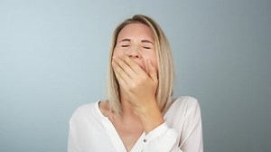 clip-1022727058-young-blonde-woman-yawning-straight-camera-feeling