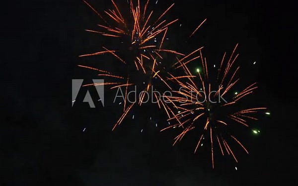Fireworks show. New year eve fireworks celebration. Christmas beautiful flashes of fire and sparks against the background of the night sky. Multiple explosions of pyrotechnics. Multicolored ceremonia