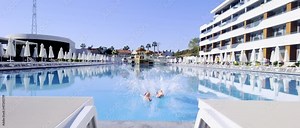 Man diving intoa sparkling swimming pool
