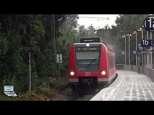 Grafing Stadt [bei Starkregenschauer] mit Südostbayernbahn, Münchner S Bahn, Bahnübergang
