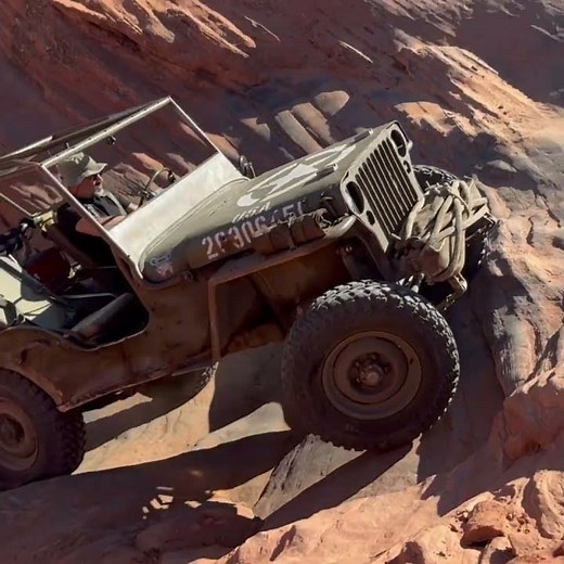 Bam Bam the Willys MB climbs the Horseshoe Falls obstacle on Sand Mountain near Hurricane, Utah.