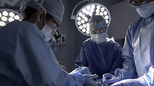 clip-3514060043-surgeons-performing-surgery-operating-room