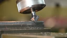 Slow motion the chamfering process on NC milling machine with chamfer...