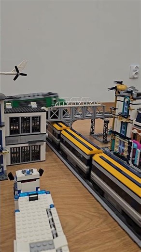 LEGO multi-level bridge layout with three trains in perfect motion 🚆
