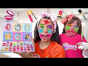 Sarah and Eloah pretend to play with makeup toys for children