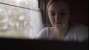 Teen girl sitting in compartment car of train in summer, traveling. The girl in the train in the compartment.
