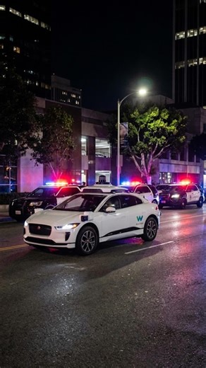 AI Innovations Hub on Instagram: "A Waymo self-driving car carrying passengers accidentally drove into an active police standoff in Los Angeles. Video from bystanders shows the vehicle turning onto a street where officers had guns drawn and a suspect was on the ground. Instead of stopping or rerouting, the car continued forward as if it were navigating a normal intersection. The moment has sparked new discussion about safety protocols, how these cars detect unusual or high-risk situations, and w