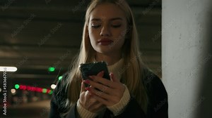 Businesswoman Caucasian woman female driver stand on car parking use mobile phone texting messages booking taxi search wi-fi upsetgirl frustrated problem failure lost internet connection underground