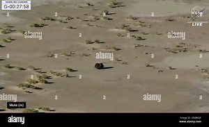 This image taken from video provided by NASA TV shows the capsule released by the Osiris-Rex spacecraft lying on the surface after landing to Earth, Sunday Sept. 24 2023. (NASA TV via AP Stock Photo - Alamy