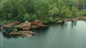 Aerial view of boat, ship and barge graveyard on the Pripyat river abandoned after Chernobyl disaster. Cemetery of ships and barges. Abandoned ships of Chernobyl. Pripyat river. Pripyat city.