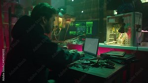 Professional hacker typing on keyboard at night, trying to break password, using laptop and bypassing cybersecurity. Young man developing program. Programmer infecting system with cyber virus