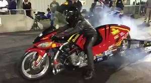 Lining up against a Pro Stock Motorcycle, Travis davis lays down a quick pass on his Timblin Chassis Pro Mod. | CycleDrag