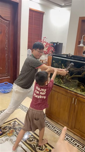 Clueless dad smashes fish tank with a microphone—here's what happened.