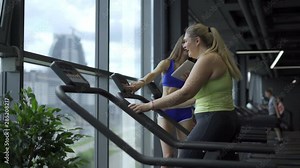 Young Plus Size Model, woman walks on a treadmill in gym, young girl trainer teaches, aerobic exercise and fat burning, slim girl and plus size body model in GYM.