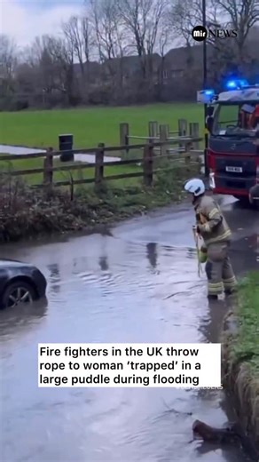 Mir News on Instagram: "JUST IN: 🇬🇧Firefighters in the UK were filmed throwing a life-safety rope to a woman who was reported as being “trapped” during flooding — but the situation quickly raised eyebrows online. The woman had called emergency services from her car, claiming she was stuck due to rising floodwater. When responders arrived, footage showed her standing in what appeared to be a large puddle rather than a dangerous current. While emergency crews treated the call serio