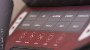 Using fat burn preset training program on the elliptical trainer. Pressing the display buttons on the console closeup.