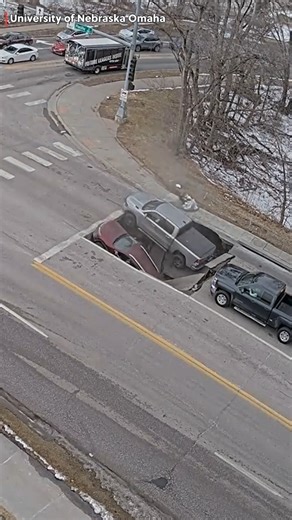 Video shows the moment a sinkhole swallowed two vehicles at an intersection in Omaha, Nebraska. | https://www.kwch.com/news/national/ #kwch12 #kwchtraffic | KWCH 12 News