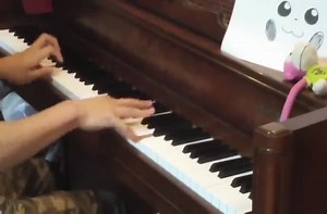 The Pokemon battle theme played on piano.